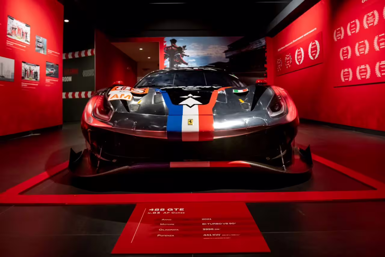 Front view of a Ferrari 488 GTE showcased in Maranello's Ferrari Museum, highlighting its sleek design and racing heritage.