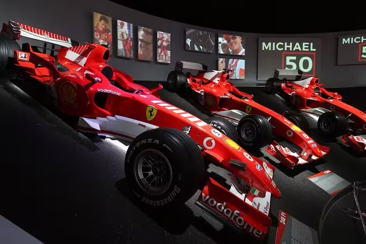 Row of legendary Ferrari Formula 1 cars in a dedicated exhibit at the Ferrari Museum in Modena on a private tour