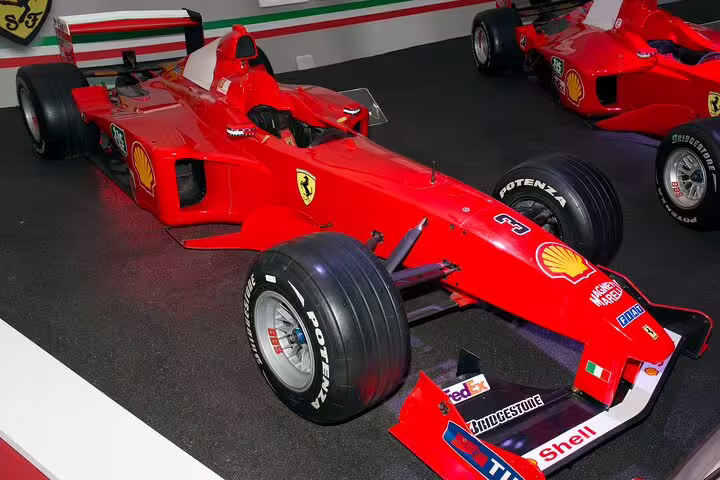 Iconic red Ferrari Formula 1 race car on display at the Ferrari Museum in Modena, Italy, featured on a private tour