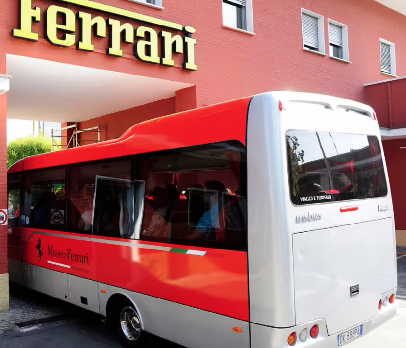 Panoramic shuttle bus outside Ferrari Museum in Maranello for Fiorano track tour and museum entrance ticket