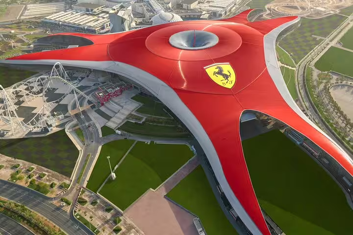 Aerial view of Ferrari World Abu Dhabi, featuring its iconic red roof and cutting-edge architectural design.