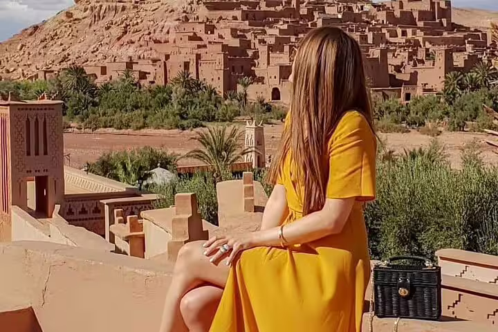 Traveler overlooking Ait Benhaddou on 3 days desert tour from Fes to Marrakech, Atlas Mountains route