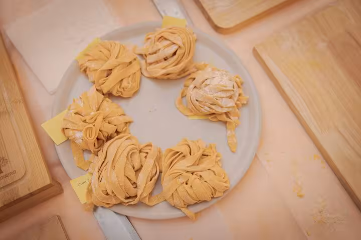 A plate of freshly prepared fettuccine nests from a pasta cooking class in Rome's Piazza Navona.