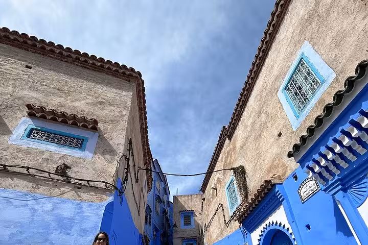 View of Chefchaouen's iconic blue buildings under a clear sky, featured in the full-day tour from Fez.