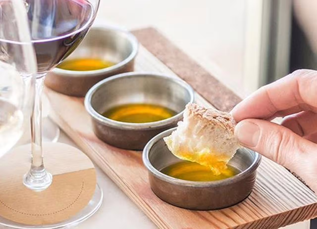 Bread dipped in extra virgin olive oil during Fiesole Olio EVO Silver Experience at Frantoio Buonamici