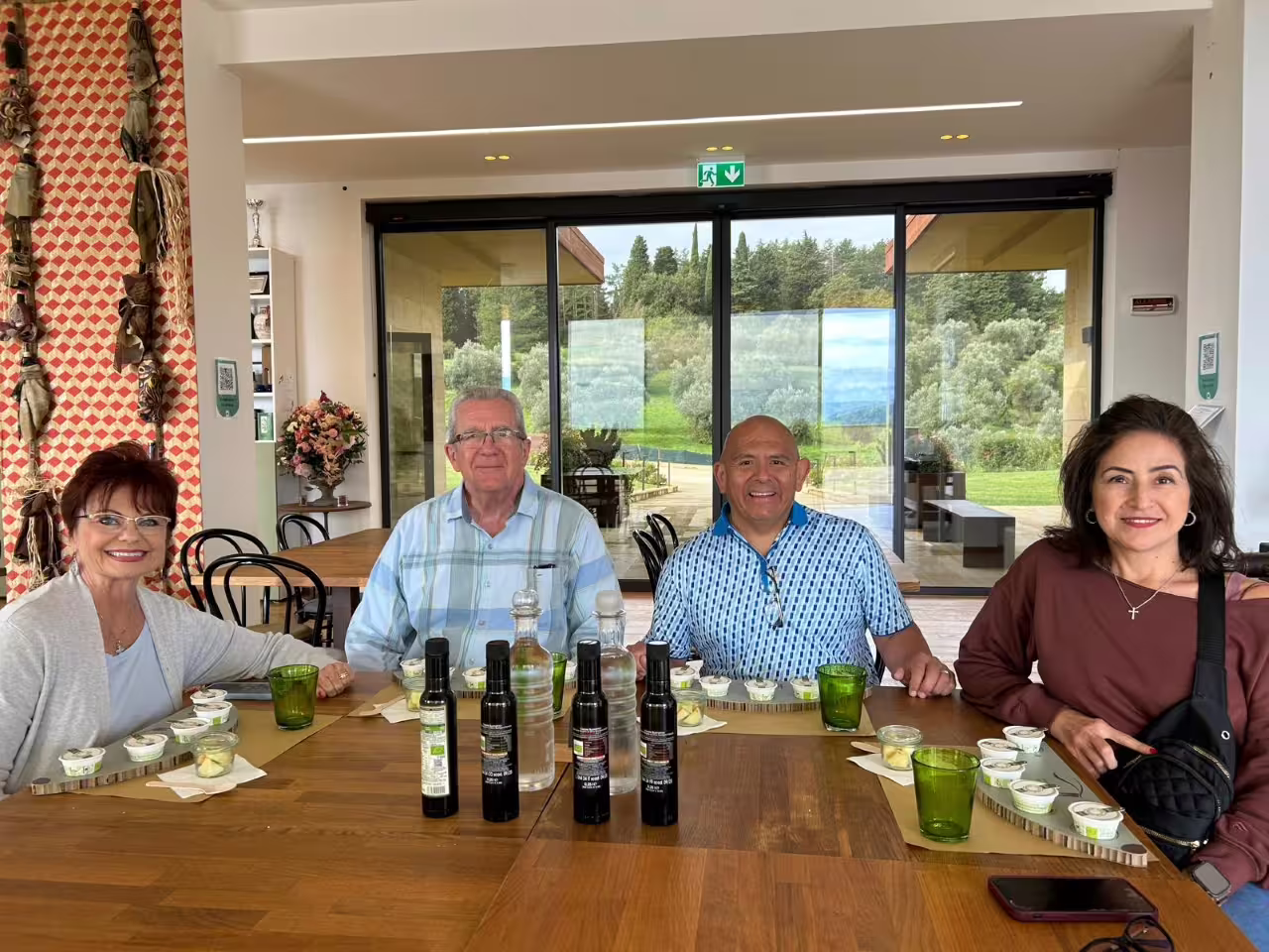Group olive oil tasting in Fiesole at Frantoio Buonamici, with EVO bottles and olive grove views