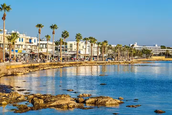 Palm-lined Finikoudes seafront in Larnaca on a Southern Cyprus sightseeing tour, with promenade and calm sea