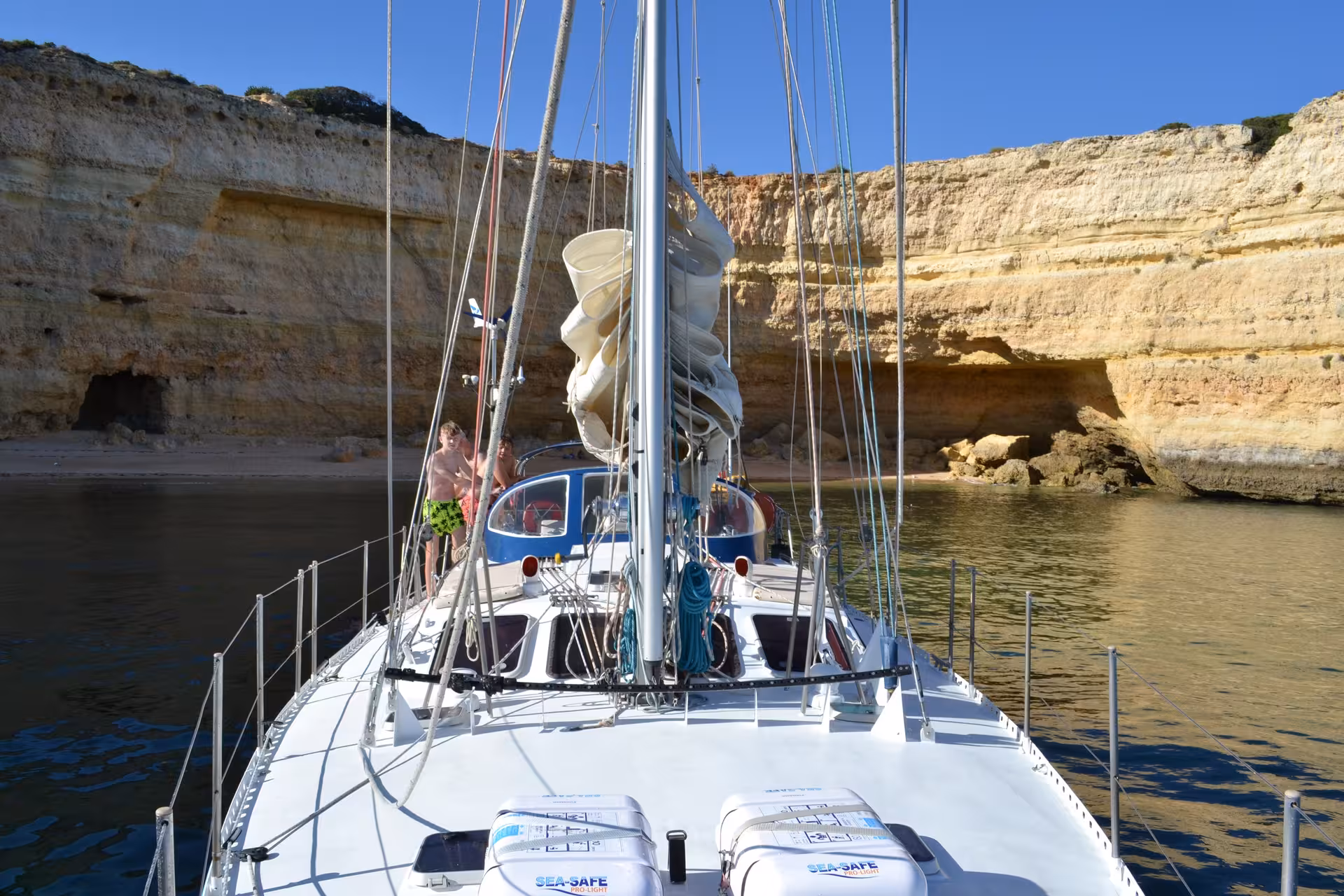 Sailboat anchored near stunning cliffs during a 3-hour FINISMAR Yacht cruise, perfect for exploring Algarve's coastline.