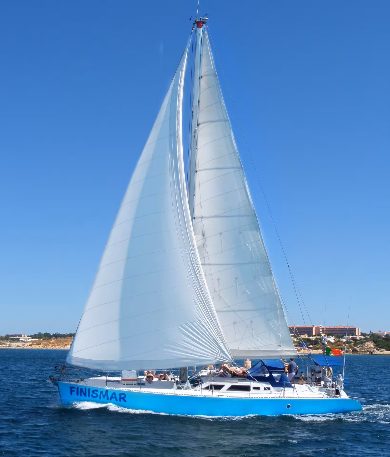 FINISMAR yacht sailing with full sails against a clear blue sky, offering a relaxing 3-hour sea cruise experience.