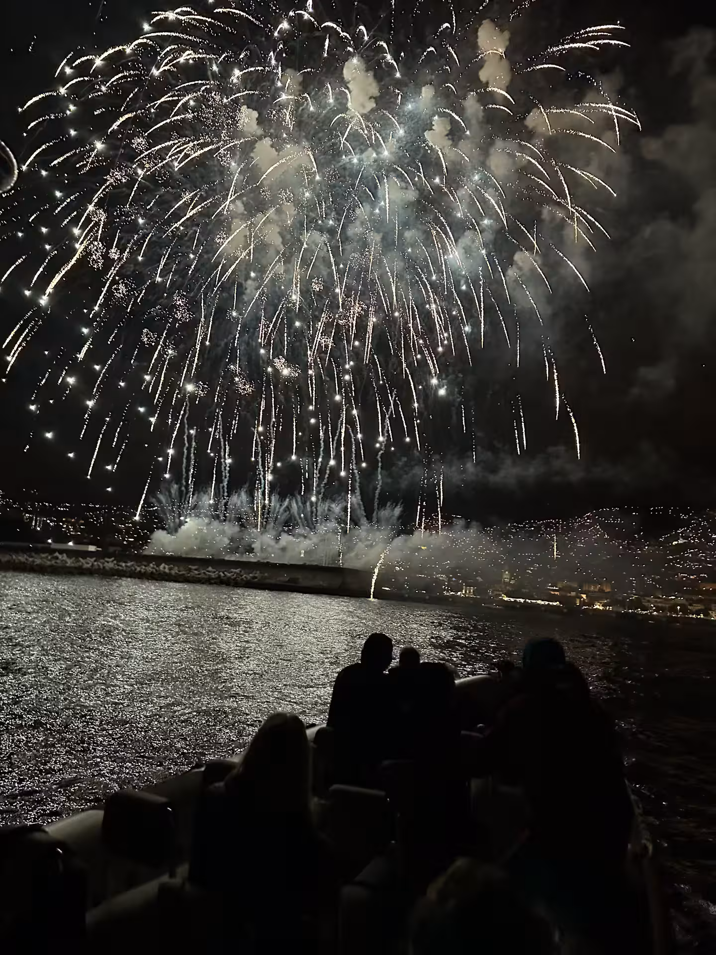 Dazzling fireworks burst over a boat tour on the ocean for New Year's Eve at June's Atlantic Festival.