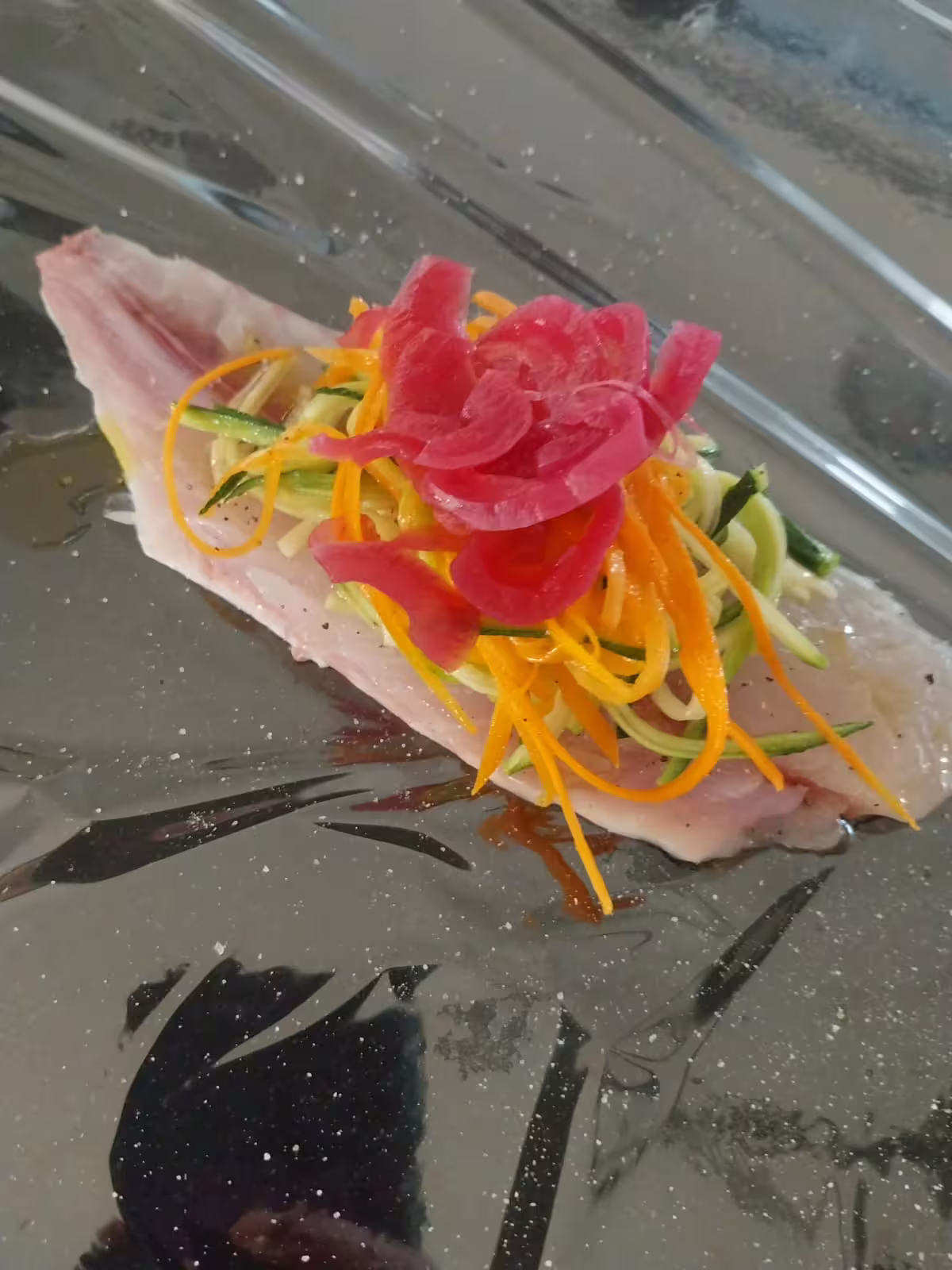 Delicate fish fillet topped with zucchini ribbons, carrots and pickled onion, served at chef Angelo Lanaro’s home