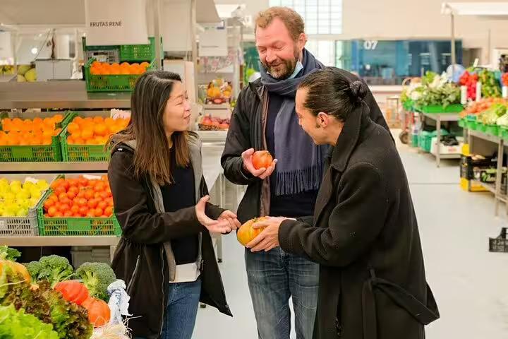 Tour participants enjoy a vibrant market experience, selecting fresh produce on the Only Fish Market Tasting Tour.
