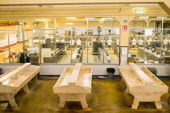 Inside a vibrant fish market, chefs prepare fresh seafood for a unique sea-to-table tasting tour experience.