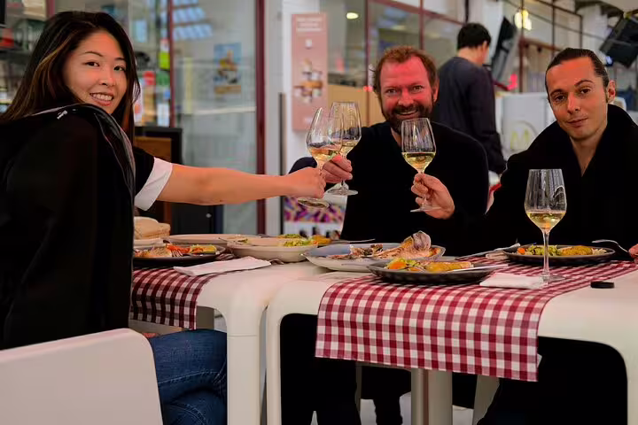 Guests enjoying a fresh seafood meal with a wine-tasting experience during the Only Fish Market Tasting Tour.