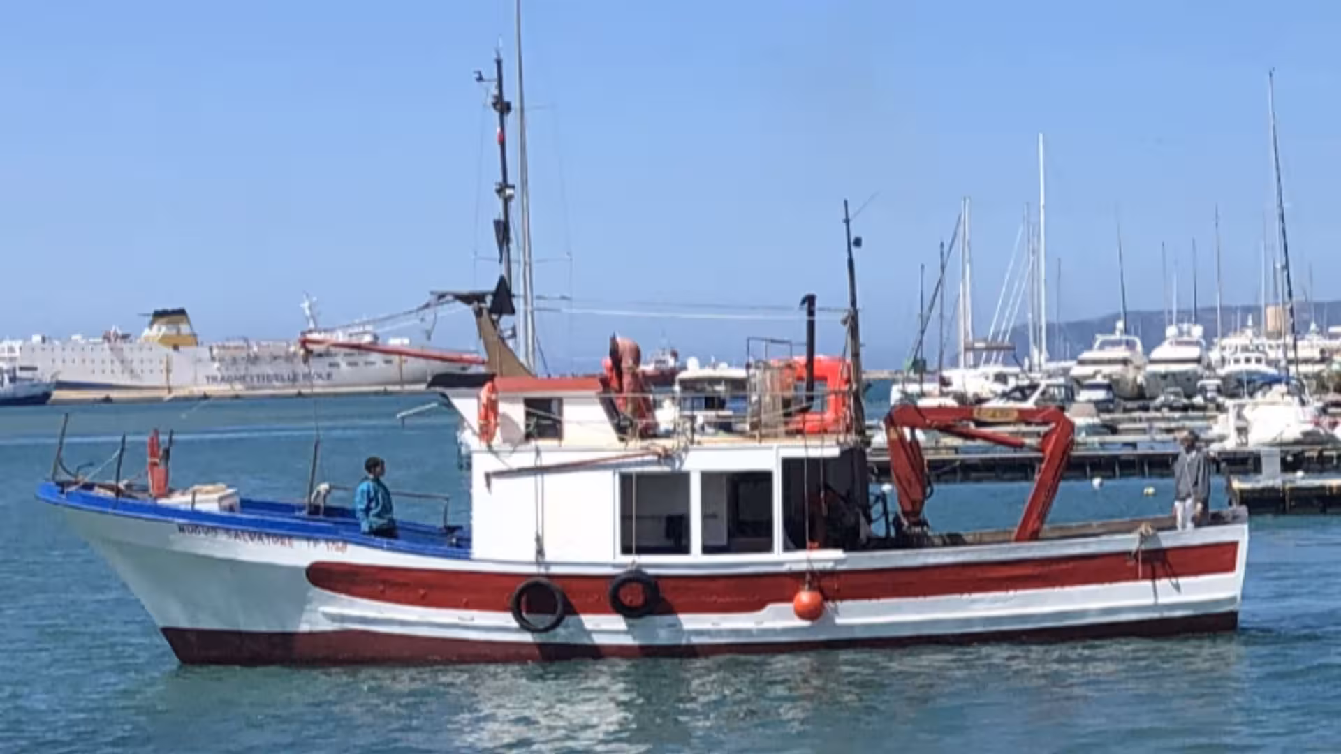 Fishing boat docked at Trapani harbor, ready for Egadi Islands fishing tourism adventure.