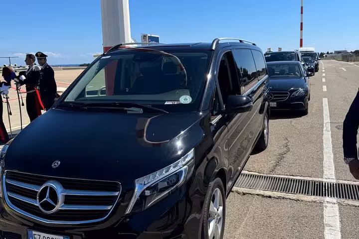 Chauffeur-driven black van at Fiumicino Airport, ensuring a seamless private transfer to Rome's city center.