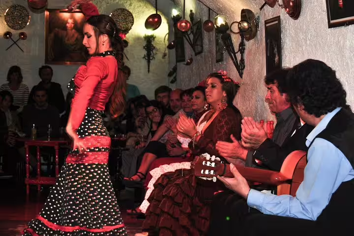 Flamenco dancer performs passionately in an intimate Barcelona setting, accompanied by live guitar and engaged audience, embodying authentic Spanish culture.