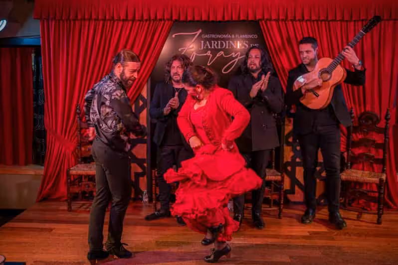 Flamenco dancers and guitarists on a red-curtained tablao during Misterios Locales + Tablao Flamenco