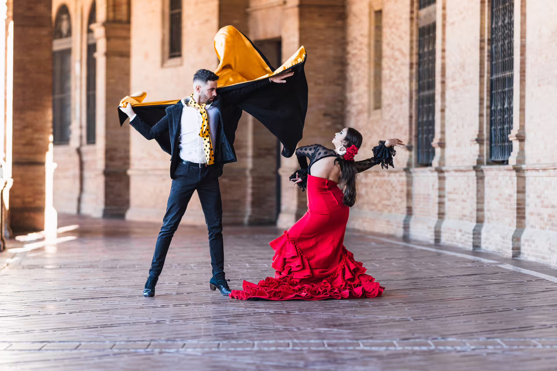 Flamenco dancers posing at Plaza de España, Seville, on a 1-day walking tour with audioguide in 7 languages