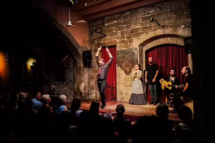 Intimate Flamenco performance in a rustic Barcelona venue with live music and dance, perfect for a tapas and wine tour experience.