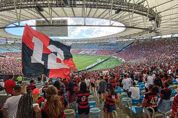 Packed Maracanã Stadium crowd waving Flamengo flag, panoramic view of matchday atmosphere on Rio football tour