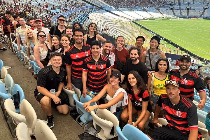 Visitors pose in Maracanã stands before Flamengo game, Rio de Janeiro stadium tour with pitch view and fans