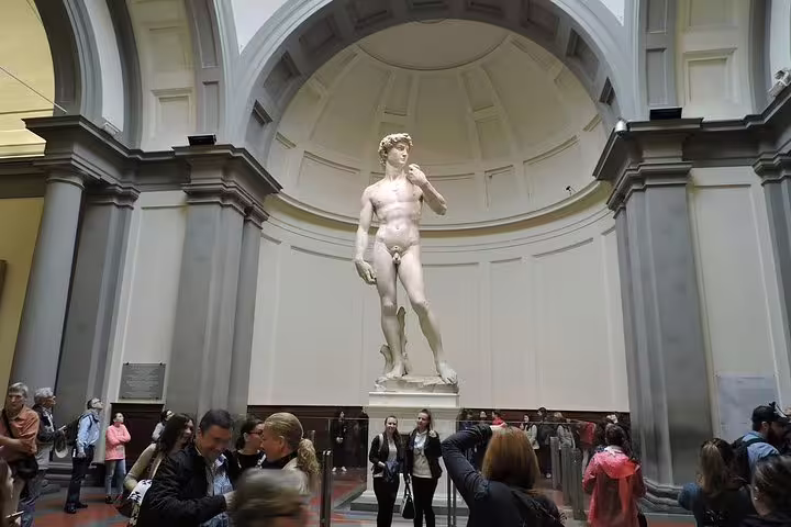Visitors admire Michelangelo’s David inside Florence’s Accademia Gallery during a small group guided tour of the museum