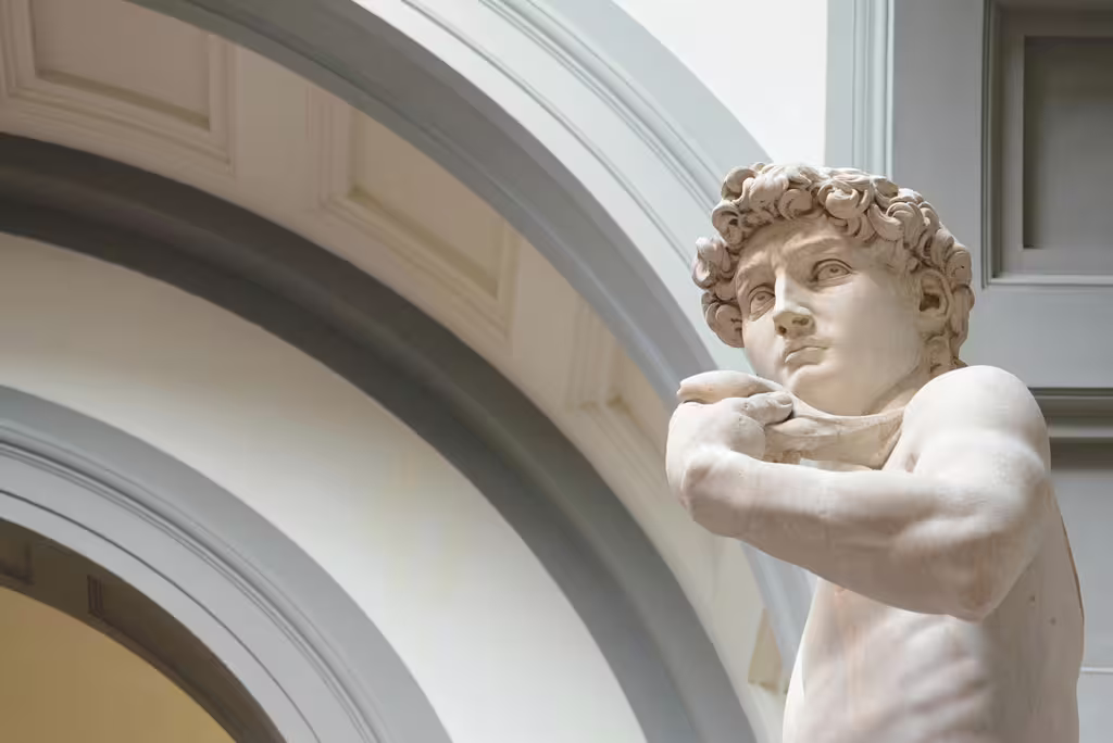Admire the detailed features of the renowned sculpture in Florence's Accademia Gallery on a day tour from Rome.