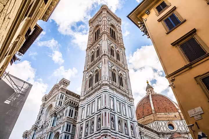 Giotto's Campanile and Florence Cathedral under a blue sky, part of Rome to Florence day trip itinerary.