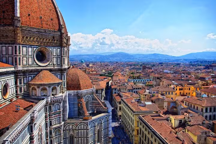 Close-up of Florence's stunning cathedral with panoramic views of the cityscape under a clear blue sky.