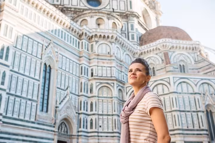 A woman gazes at the intricate facade of Florence's iconic cathedral during a Renaissance discovery tour.