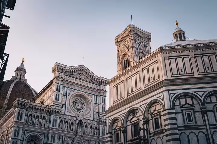 Stunning view of Florence Cathedral and Giotto's Campanile at sunset, ideal for a Rome to Florence day tour.