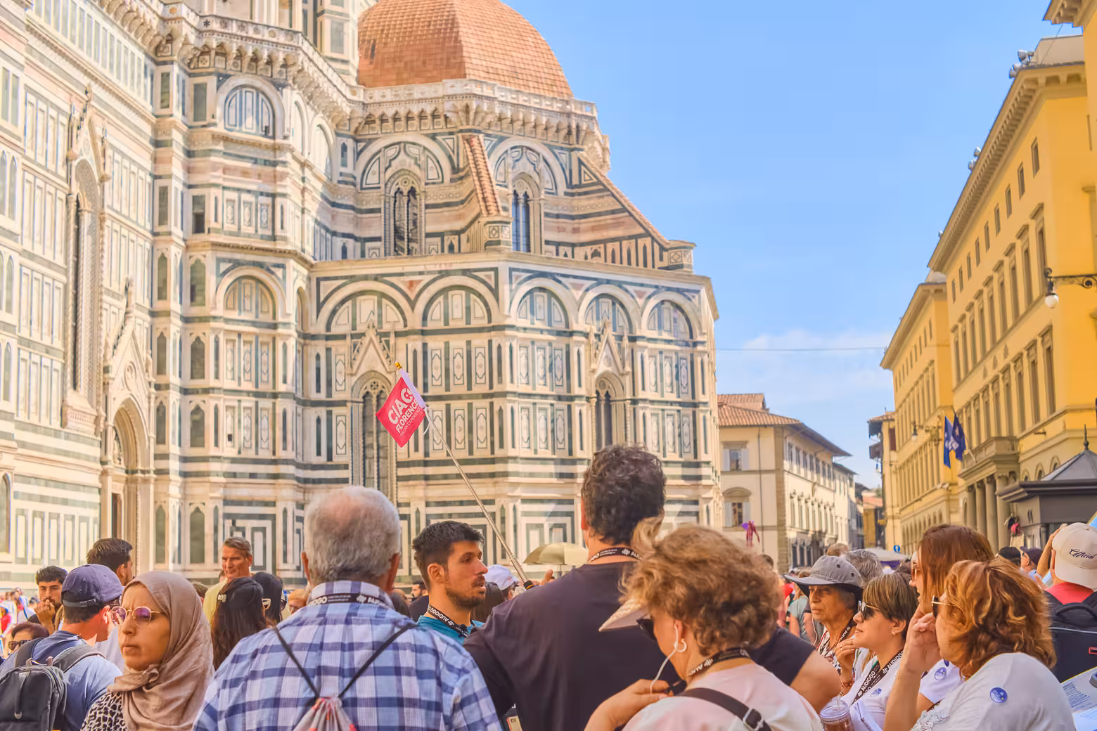 Tourists gather outside Florence Cathedral on a sunny day during a walking tour of Florence.