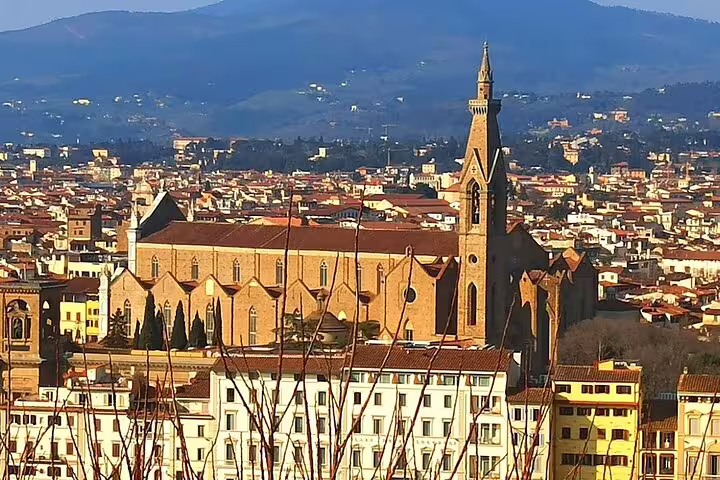Florence cityscape with historic church and Tuscan hills, featured on a private Florence and Chianti wine tour from Livorno