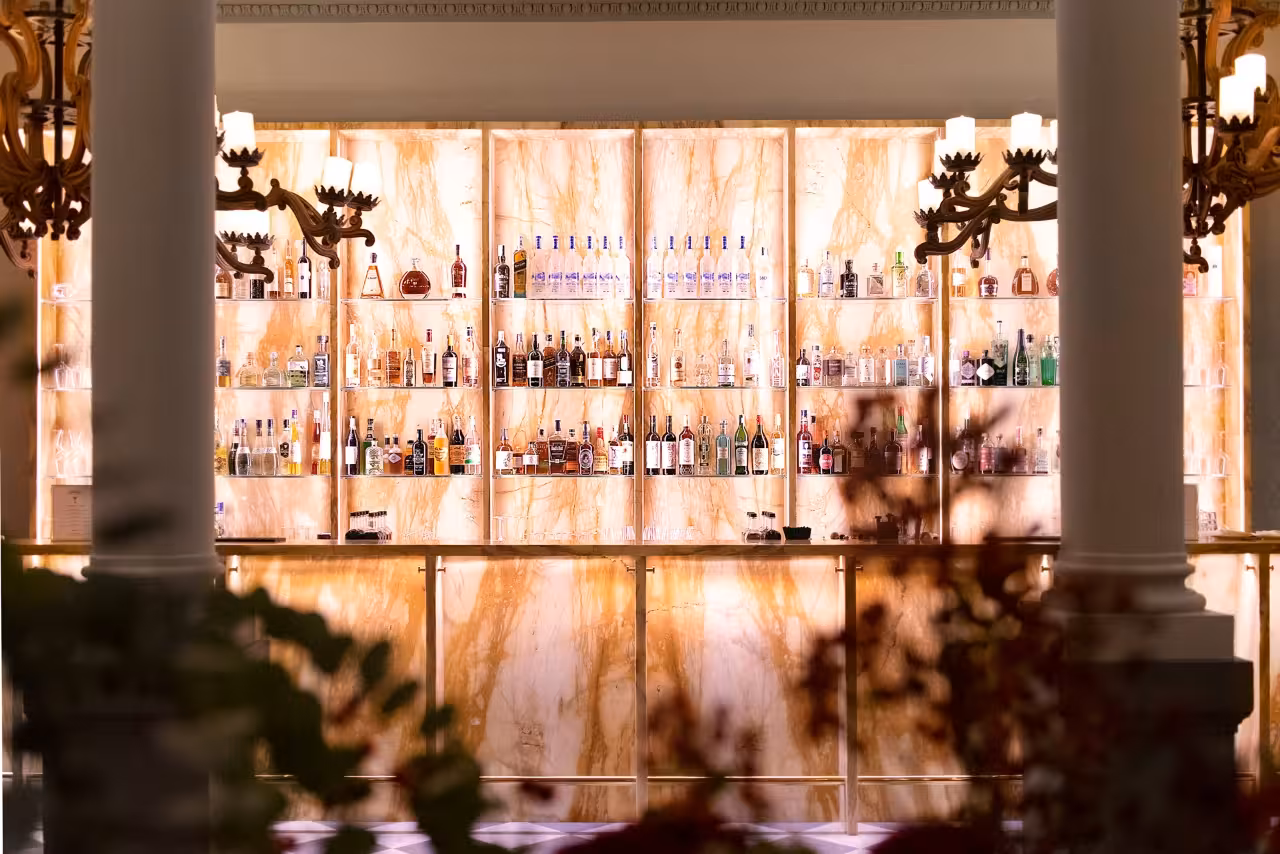 Backlit marble cocktail bar at Cibrèo in Florence, showcasing premium spirits for the culinary experience tour