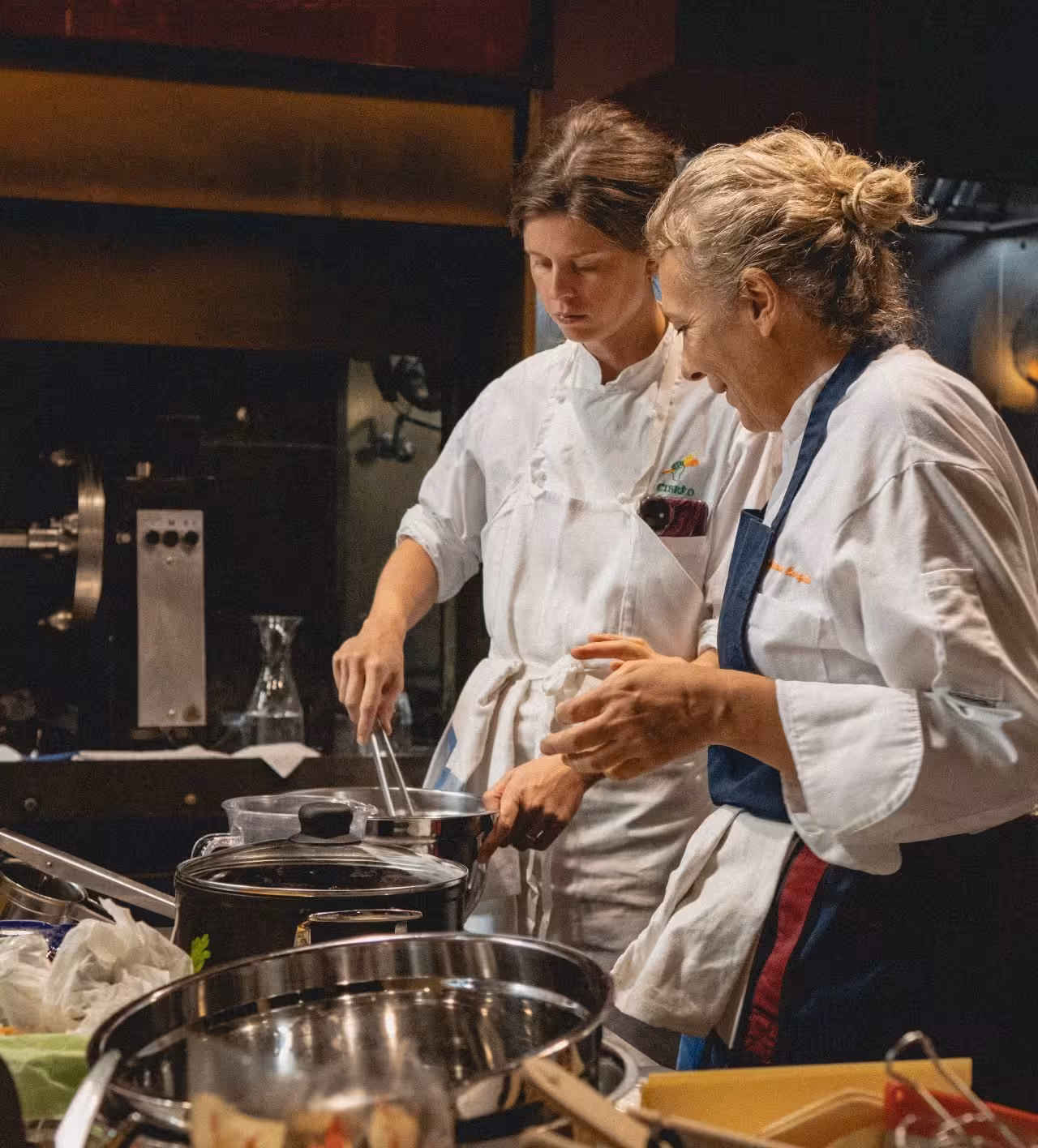 Chefs cooking in Cibrèo kitchen during exclusive Florence cooking class at Helvetia & Bristol hotel