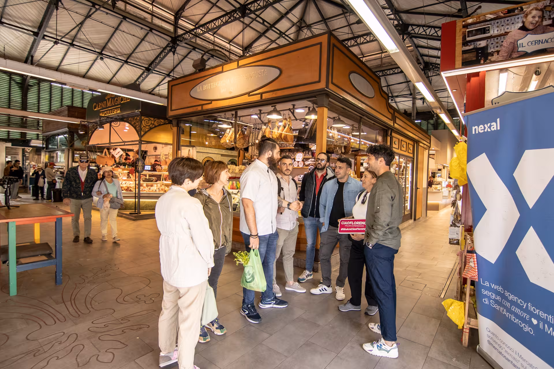 Tour group in Florence market exploring fresh ingredients and Tuscan culinary delights during a cooking adventure.