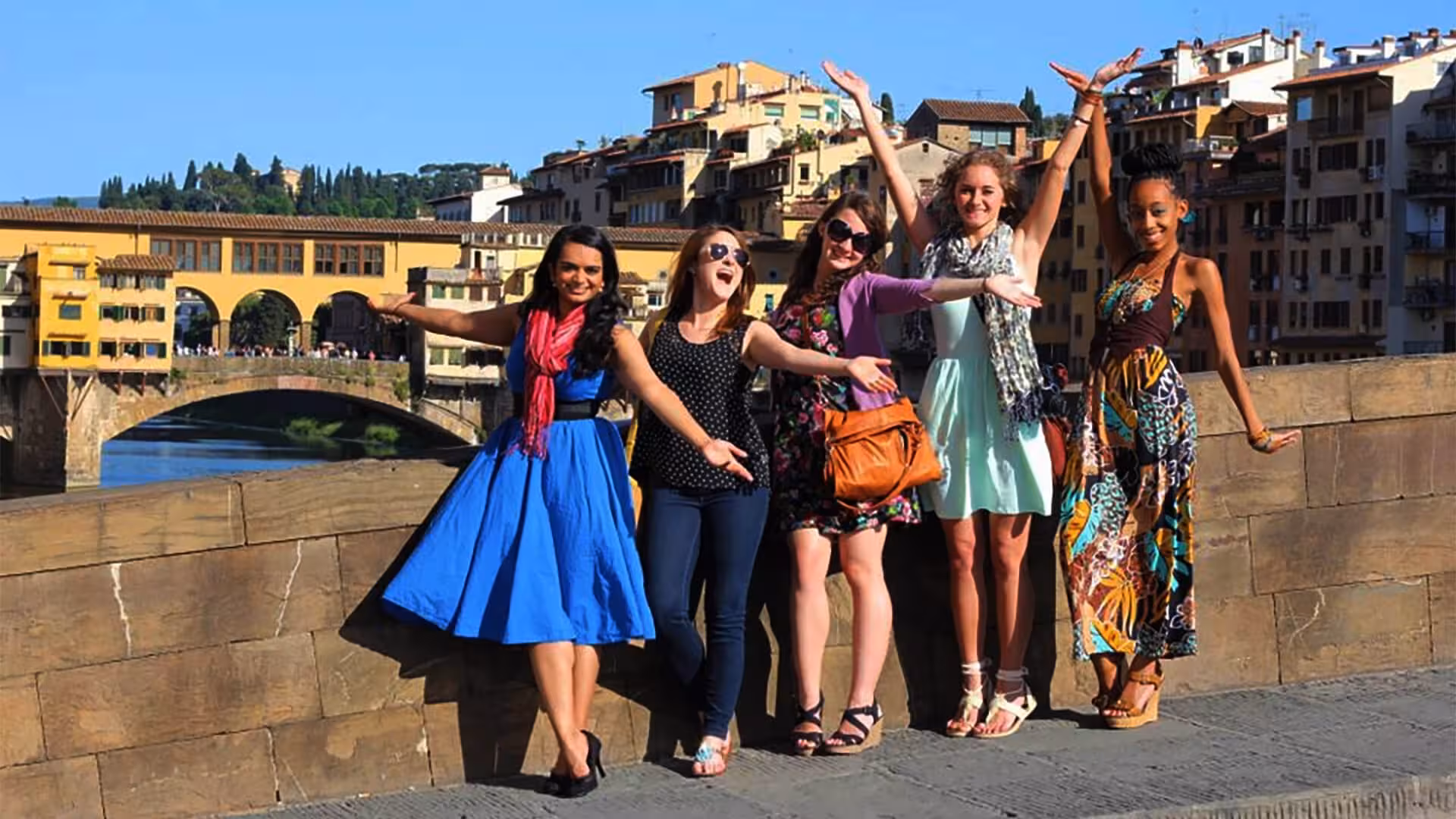 Group of friends enjoying a sunny day at Ponte Vecchio during a Florence day tour.