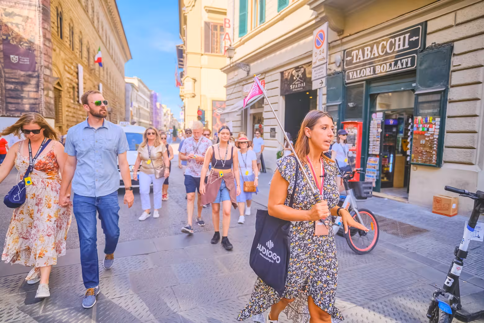 Tourists explore Florence's vibrant streets near the Duomo Complex with a guide, enjoying an immersive cultural experience.