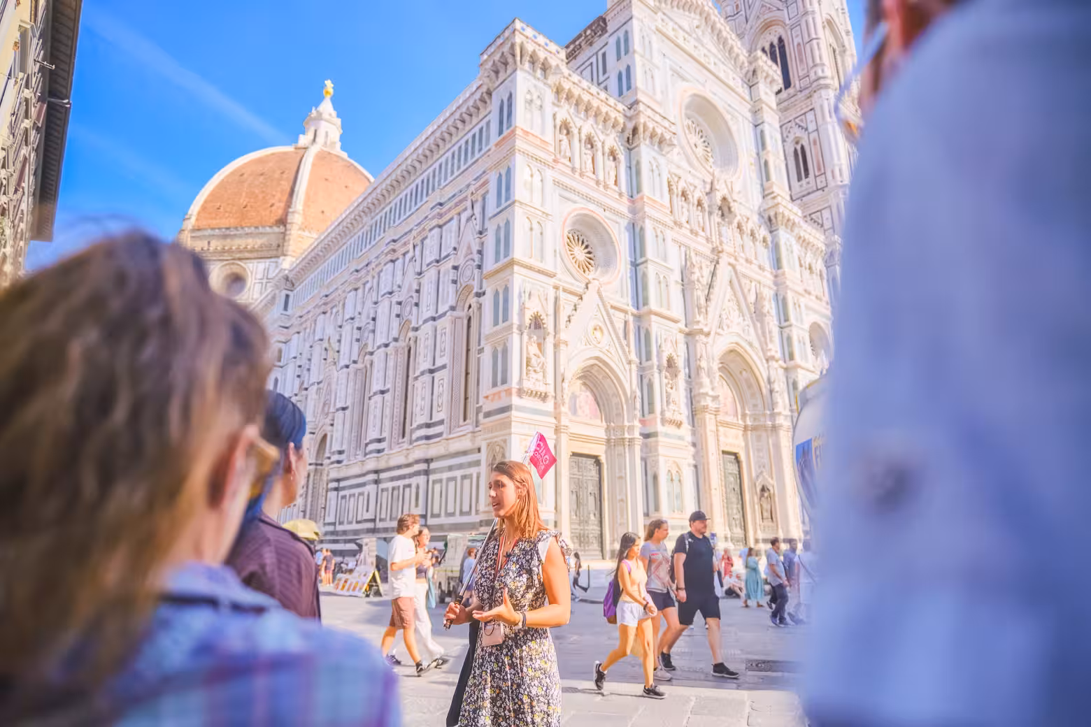 Tourists explore Florence's Duomo Complex with a guide, highlighting the architectural beauty and cultural history.