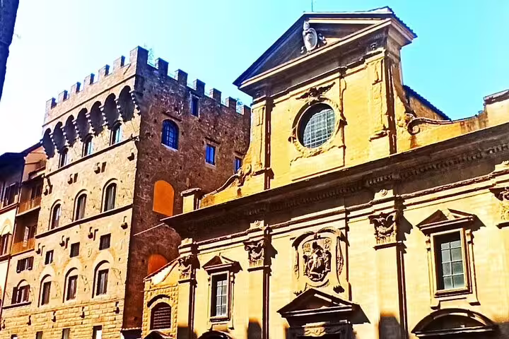 Historic stone palazzo and ornate church facade in central Florence seen on La Spezia and Carrara day trip tour