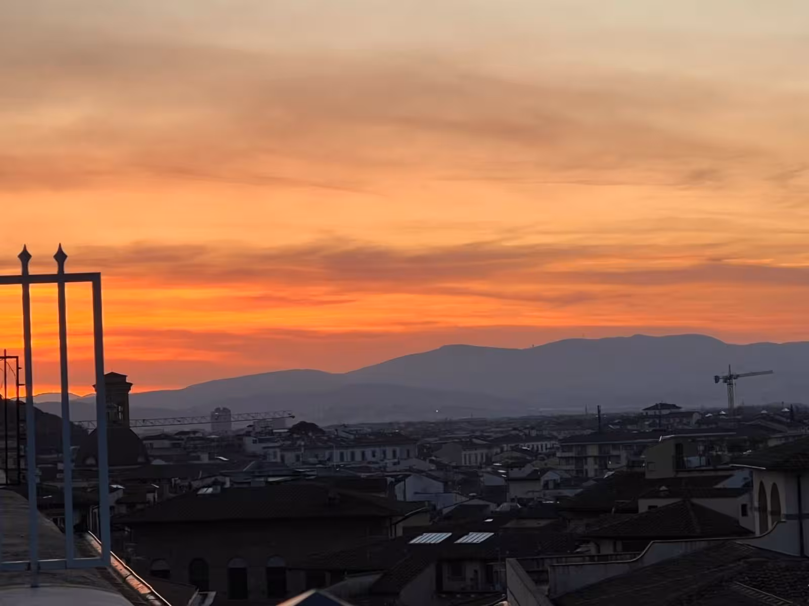Stunning Florence sunset view from an exclusive rooftop, perfect for a luxurious wine tasting experience.