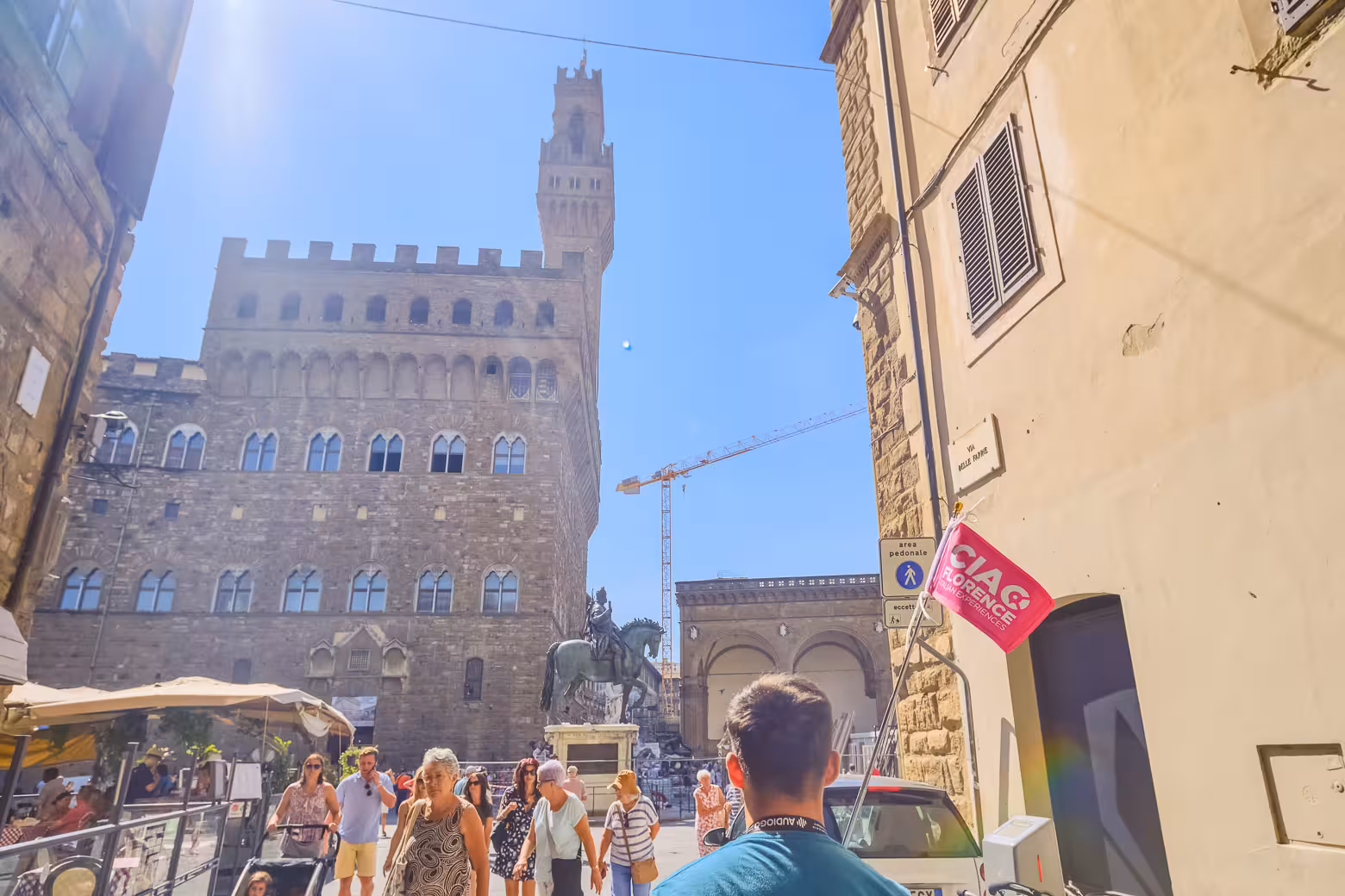 Visitors enjoy a sunny day at Piazza della Signoria with views of Palazzo Vecchio during a Florence shore excursion.