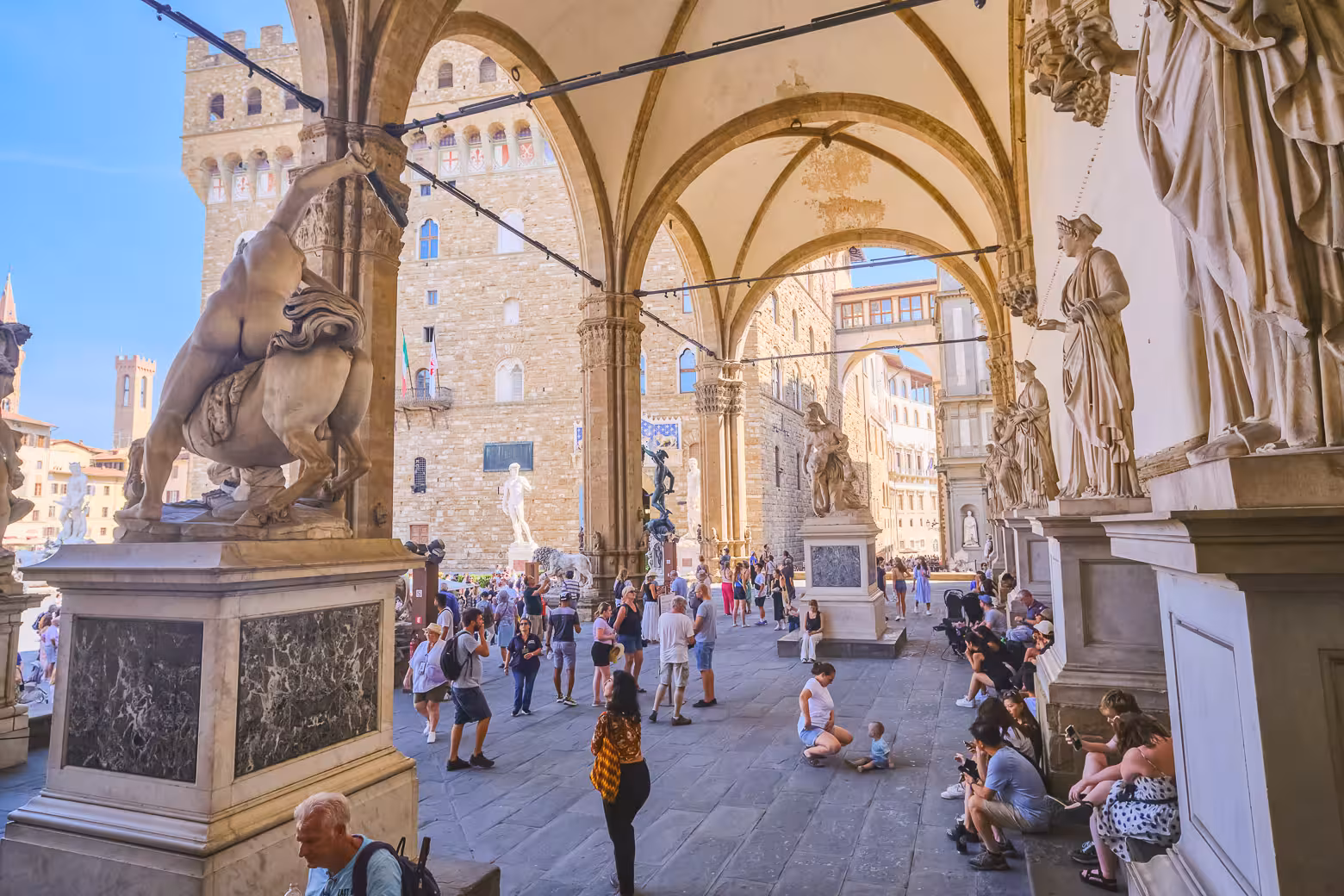 Tourists explore the historic statues and architecture of Piazza della Signoria in Florence during a shore excursion.