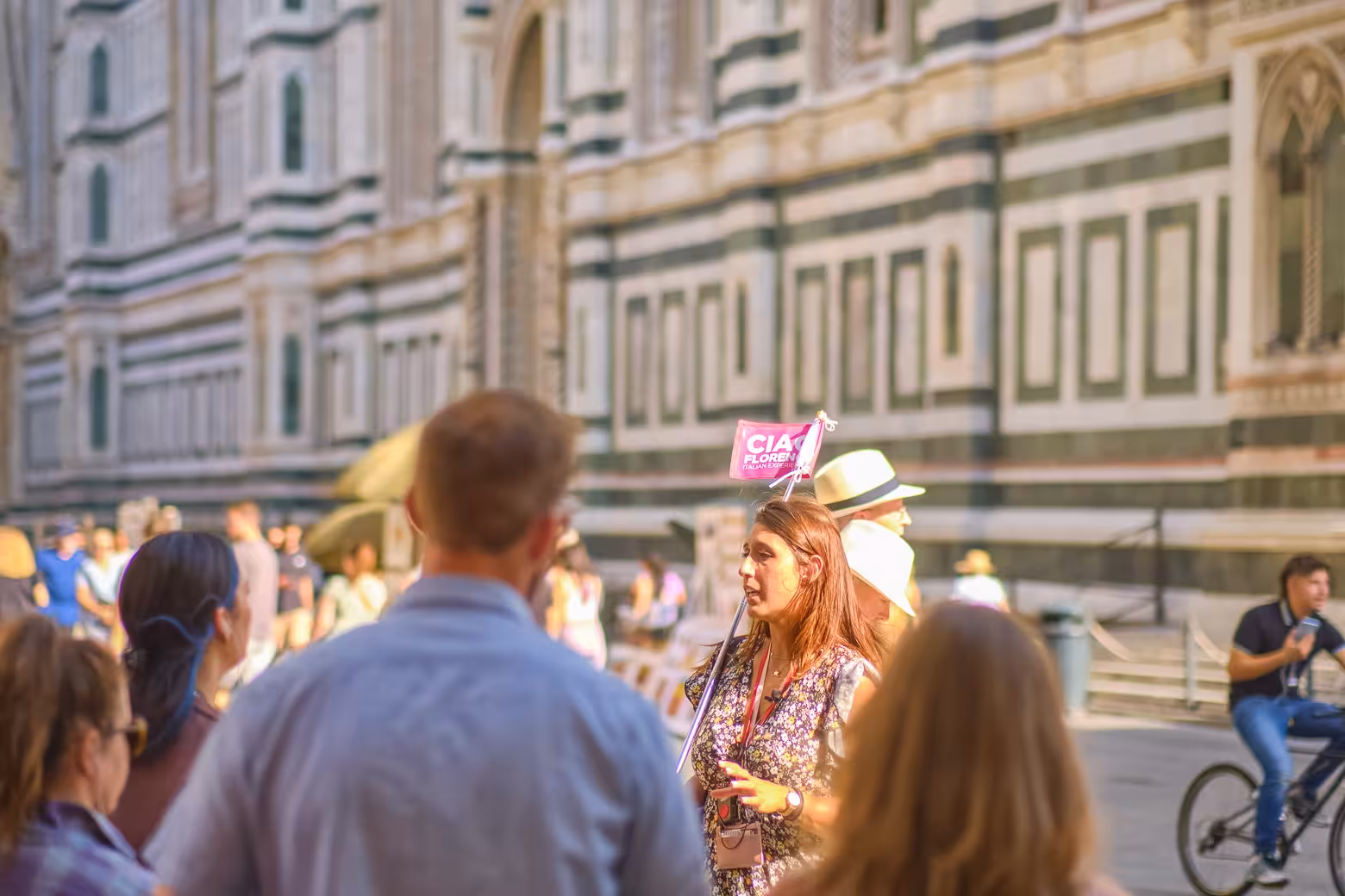 Tour guide leads a group in front of Florence's historic cathedral during a full day shore excursion.