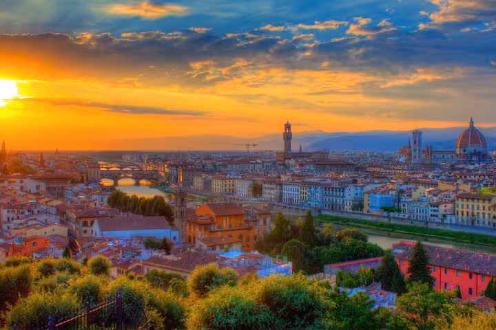 Breathtaking sunset view of Florence with the Arno River and iconic skyline on a day trip from Rome.