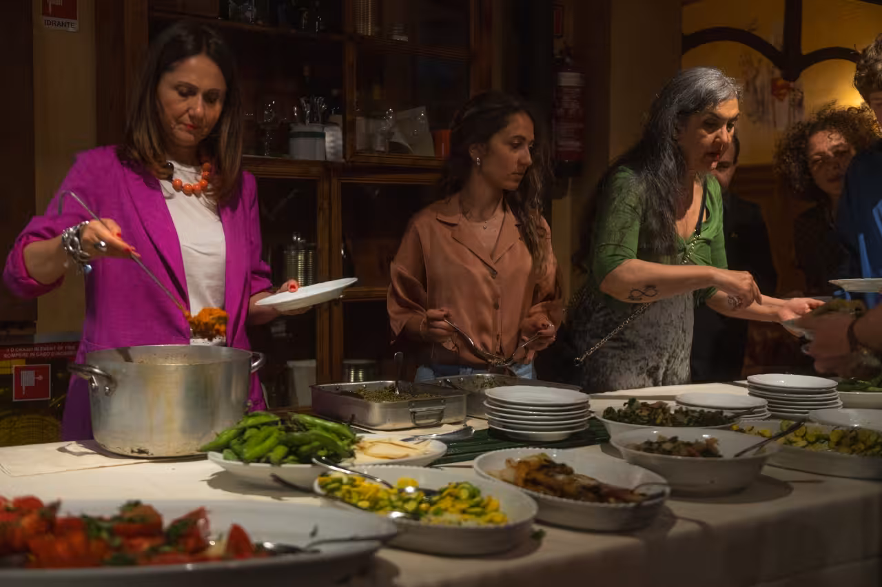 Guests serve themselves Tuscan buffet dinner at Florence Teatro del Sale before the live show and performance