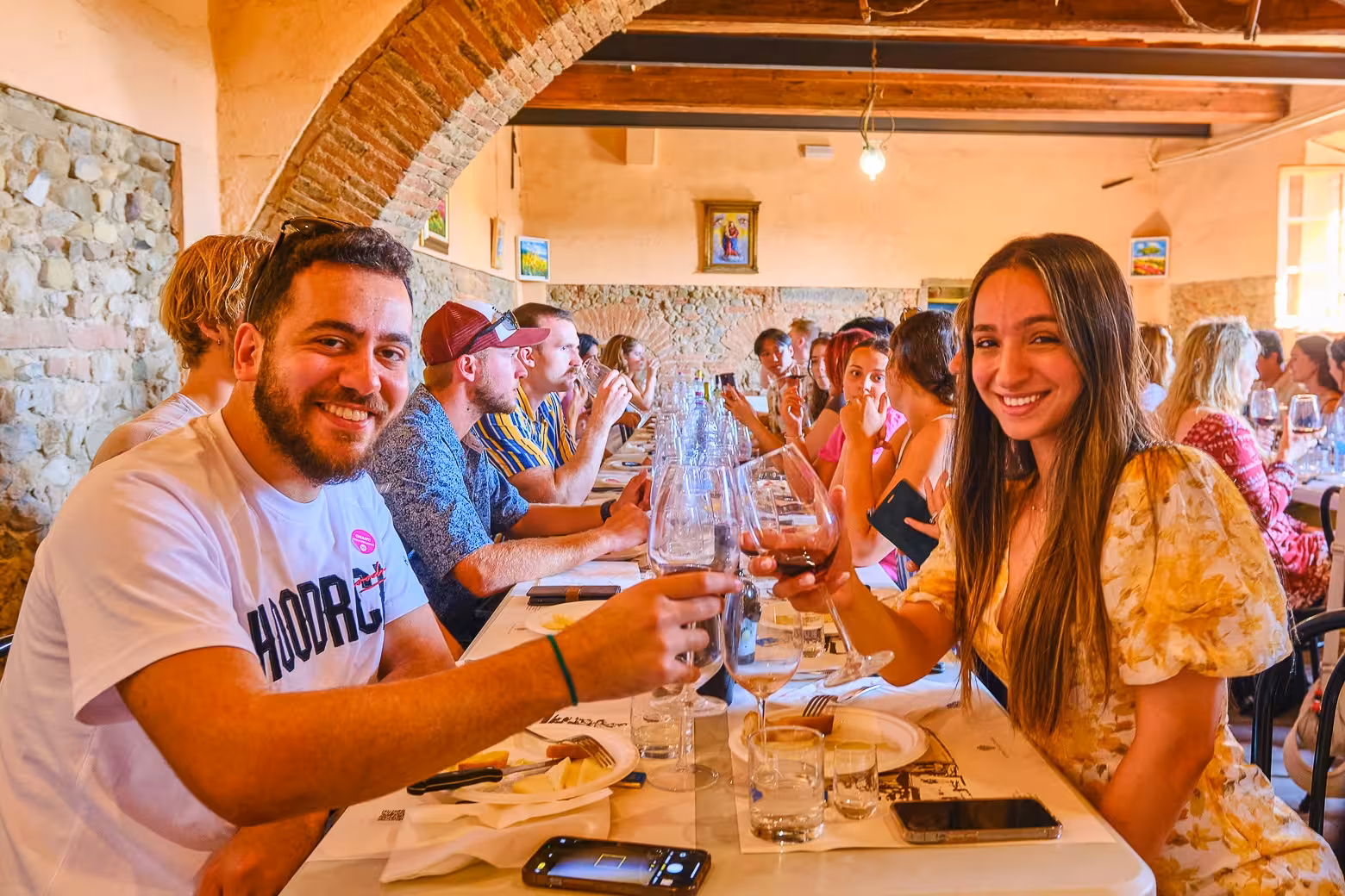 Guests enjoying a lively wine tasting session in Florence, sharing a toast during the exclusive small-group tour.