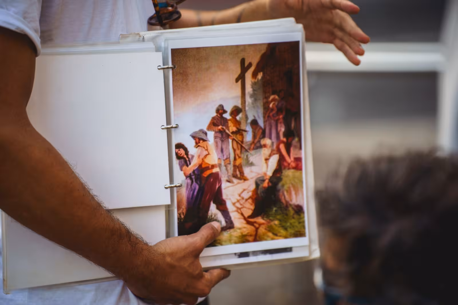 Guide showcasing historical artwork during a Florianopolis walking tour, highlighting the city's rich cultural past.