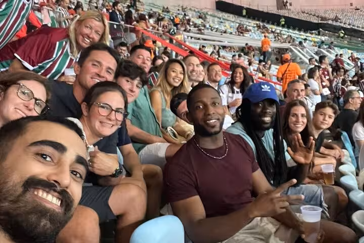Group of travelers in Maracanã stands during Fluminense game, Rio de Janeiro soccer match tour experience